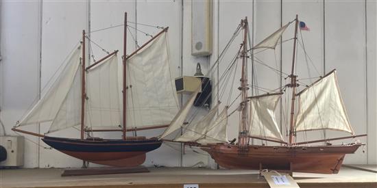 2 model sailing vessels with masts and sails